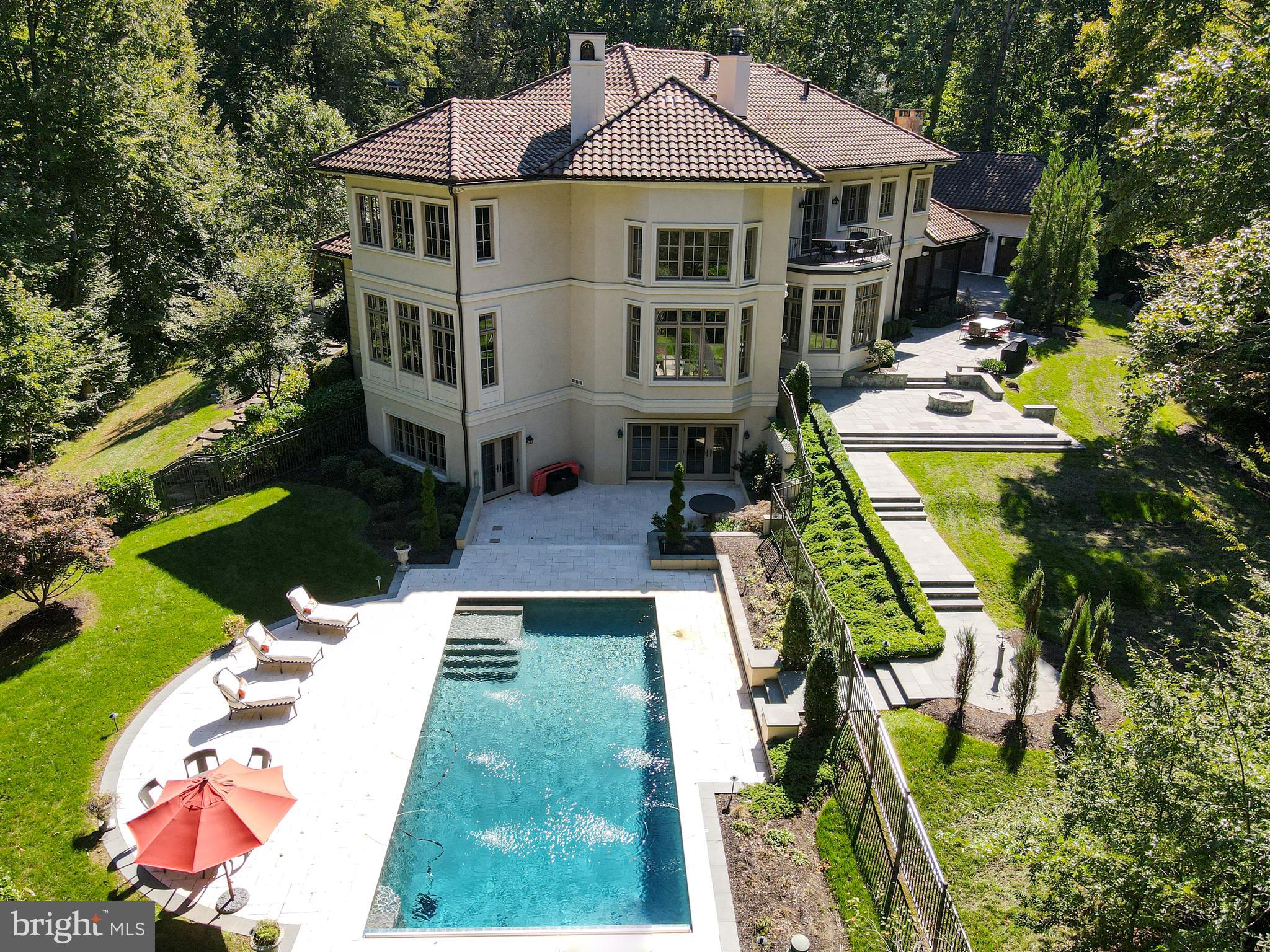 906 Turkey Run Road McLean, VA 22101 - Photo 42 of 52 a aerial view of a house with swimming pool lawn chairs and a yard