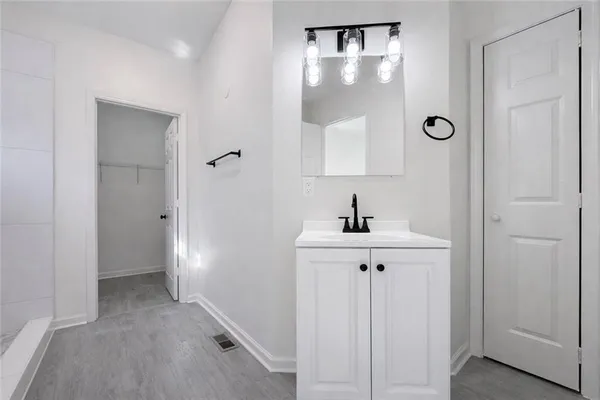 a bathroom with a sink a mirror and a shower