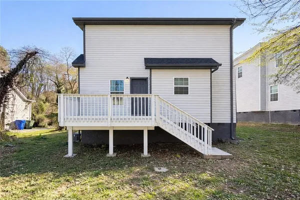 a view of a house with a yard and sitting area