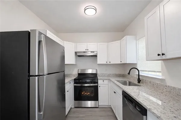 a kitchen with a refrigerator and a sink