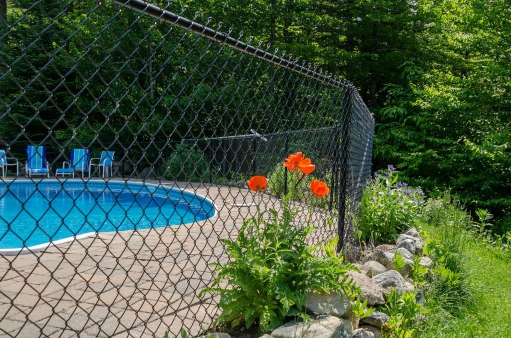 30 Conesca Road Raymond, ME 04071 - Photo 30 of 35 pool area surrounded by beautifully...
