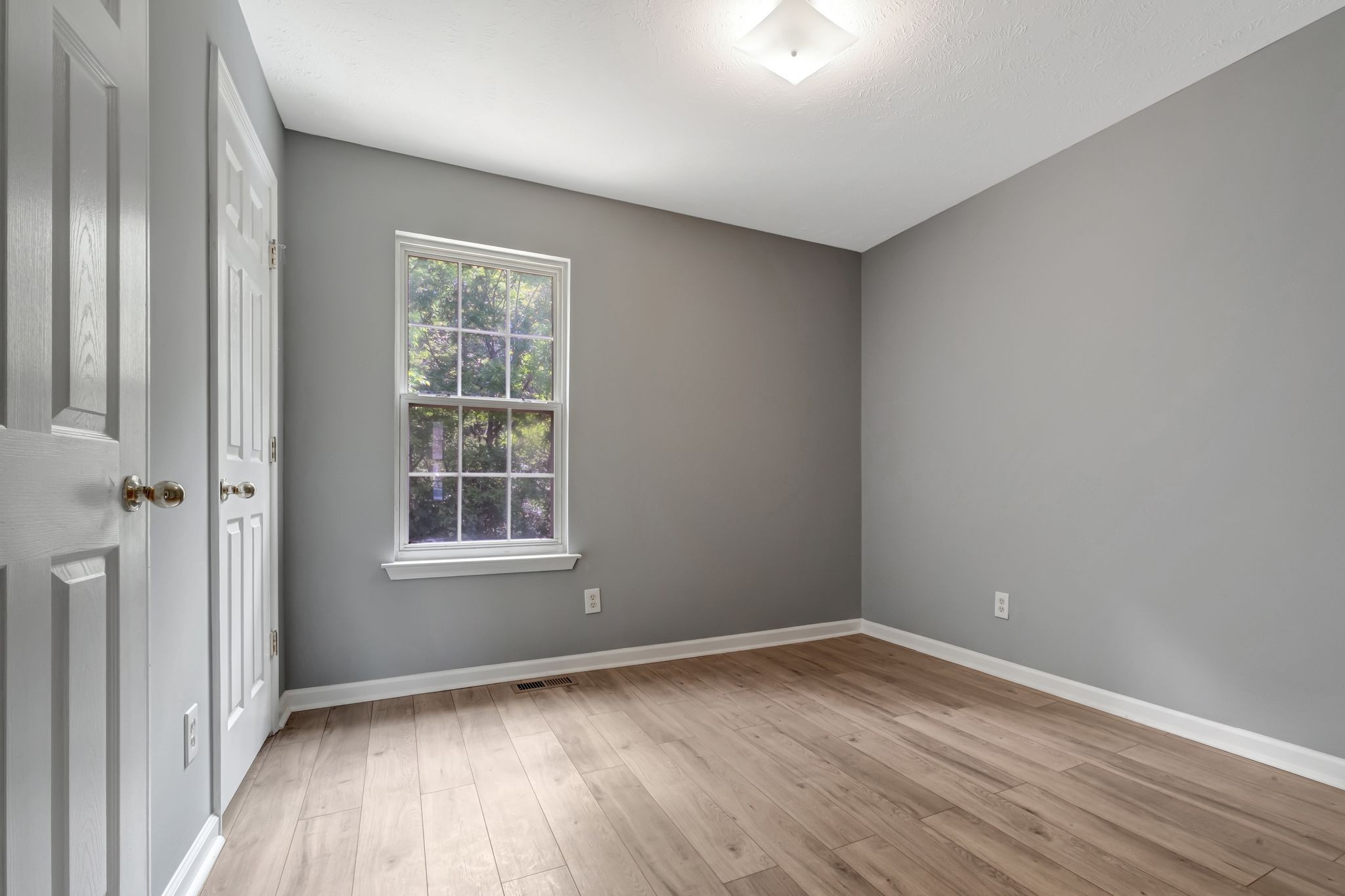 609 Big Riv Run Antioch, TN 37013 - Photo 14 of 24 an empty room with wooden floor and windows