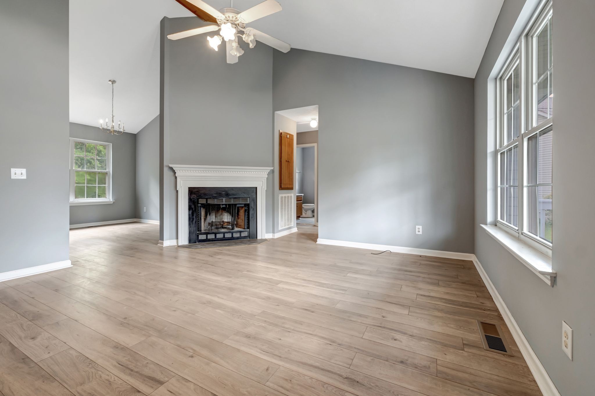 609 Big Riv Run Antioch, TN 37013 - Photo 5 of 24 a view of an empty room with wooden floor fireplace and a window