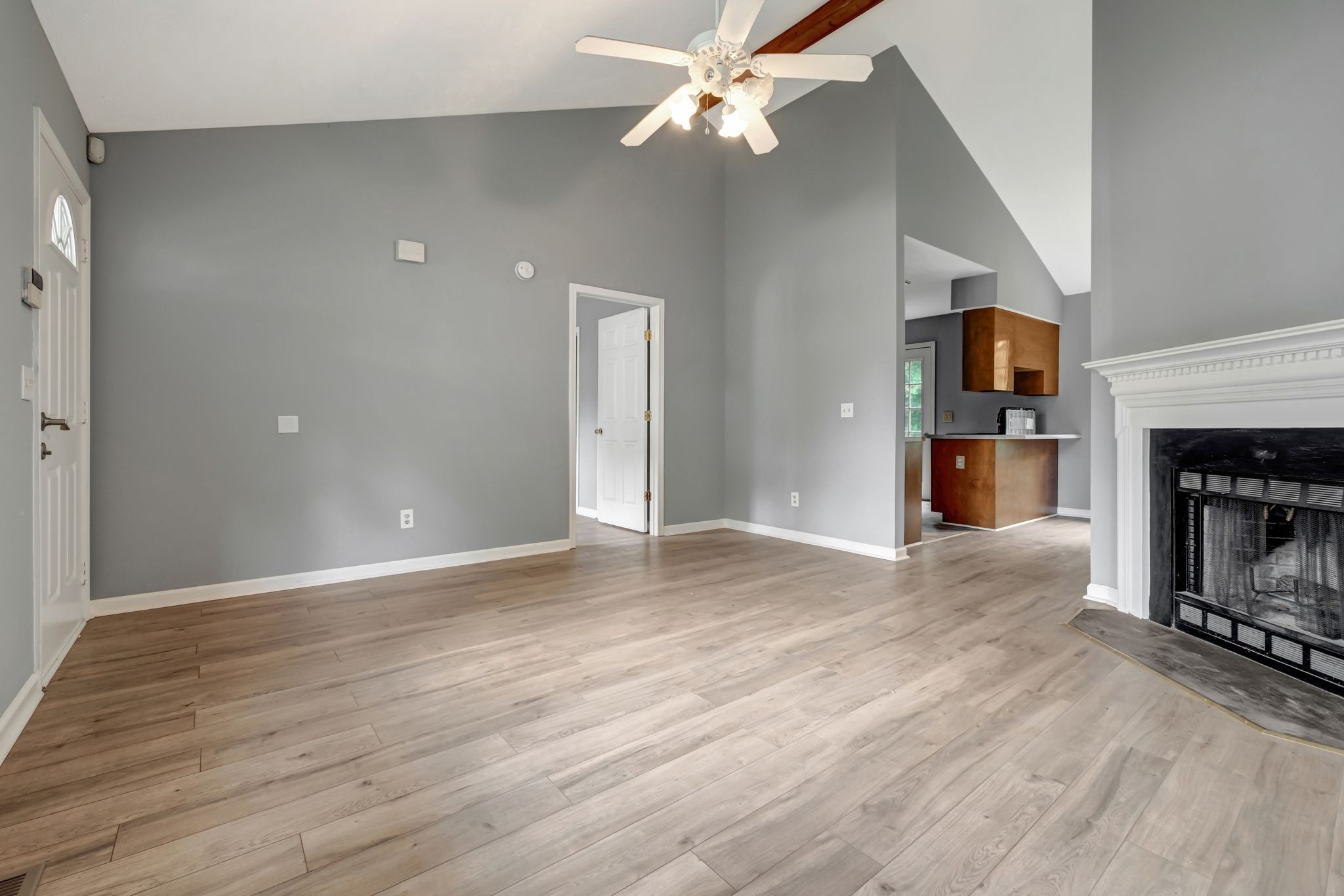 609 Big Riv Run Antioch, TN 37013 - Photo 7 of 24 a view of a livingroom with a fireplace a ceiling fan and wooden floor