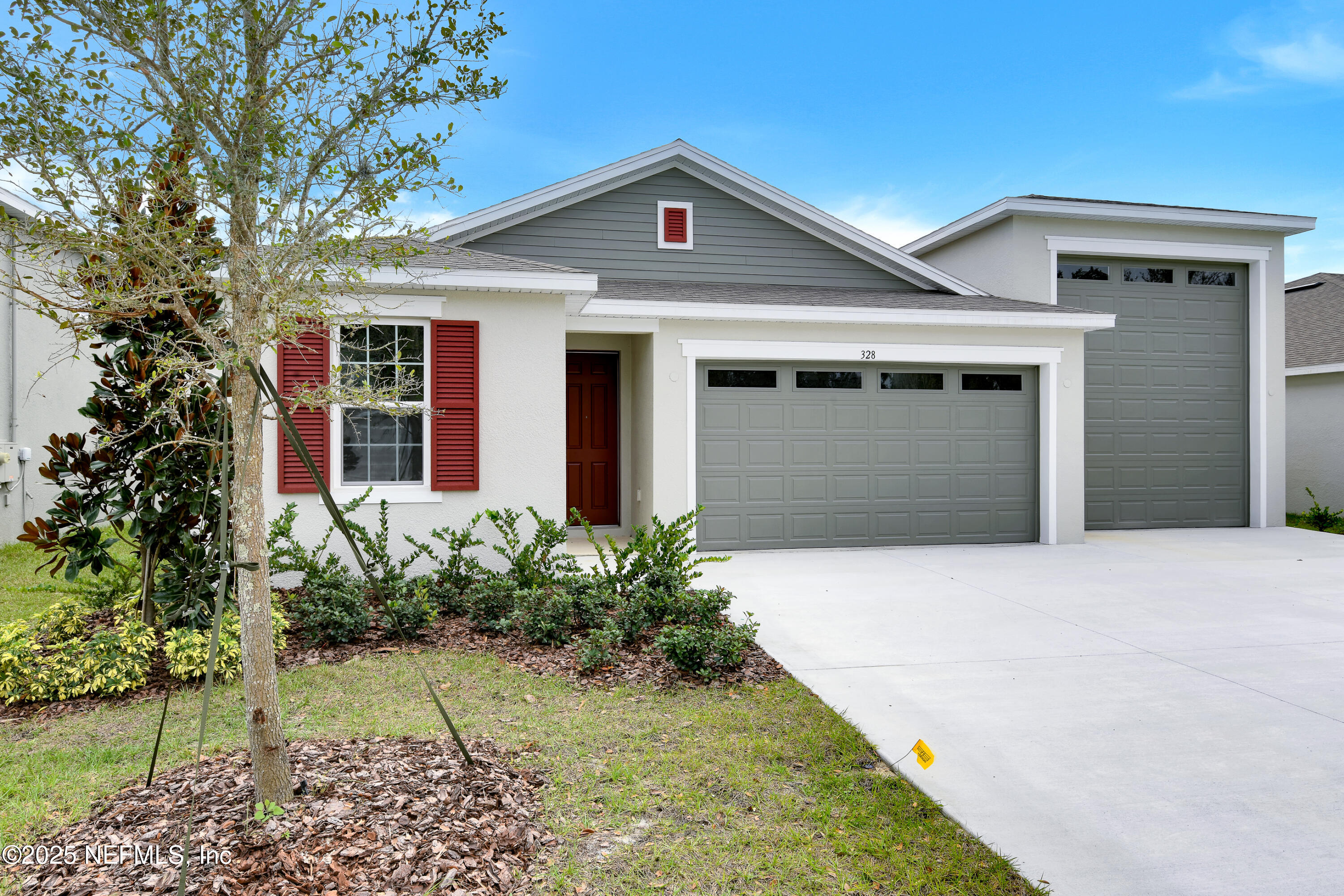 328 Alexandrite Street DeLand, FL 32720 - Photo 2 of 16 a front view of a house with a yard