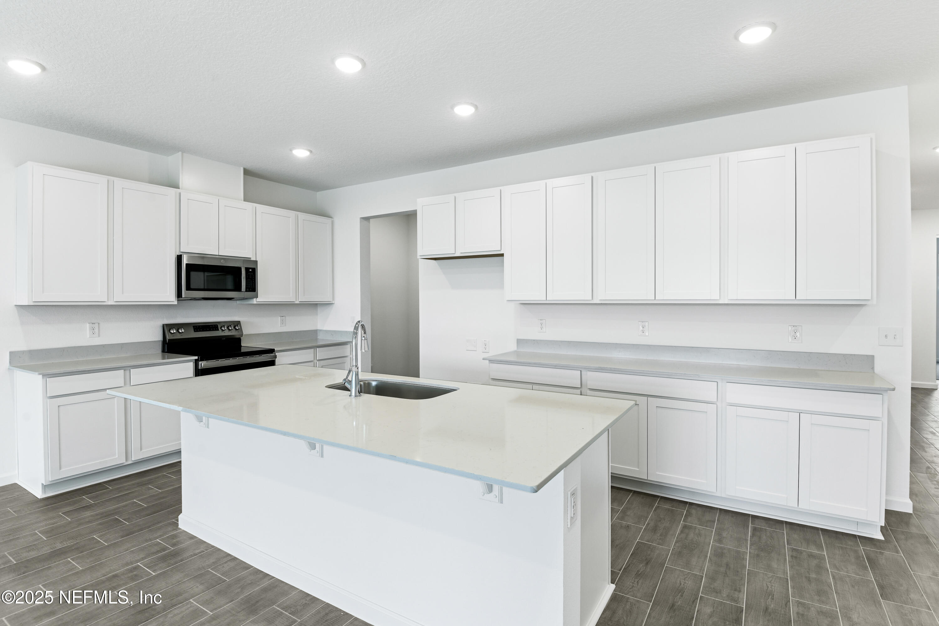 328 Alexandrite Street DeLand, FL 32720 - Photo 7 of 16 a kitchen with cabinets appliances a sink and a counter top space