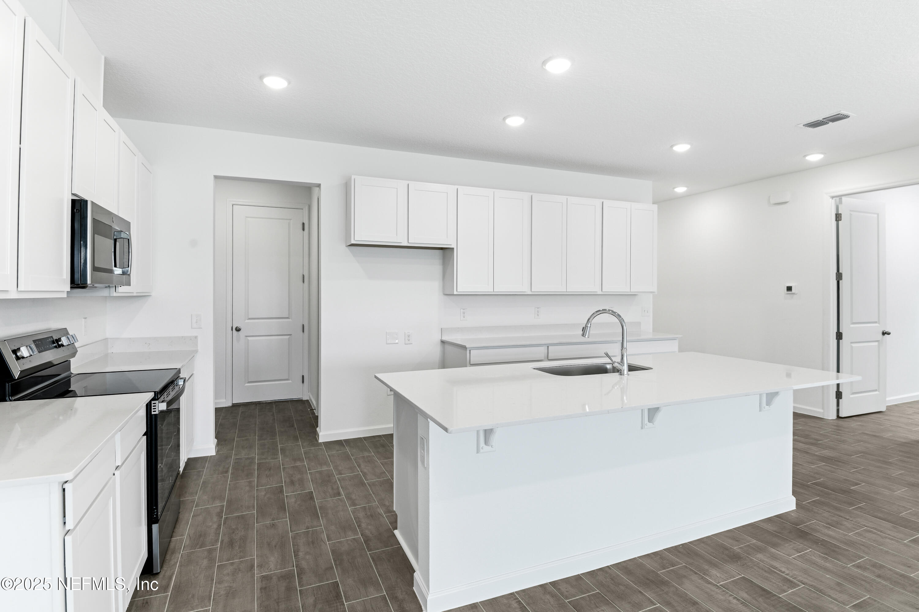 328 Alexandrite Street DeLand, FL 32720 - Photo 8 of 16 a kitchen with a sink stove and refrigerator