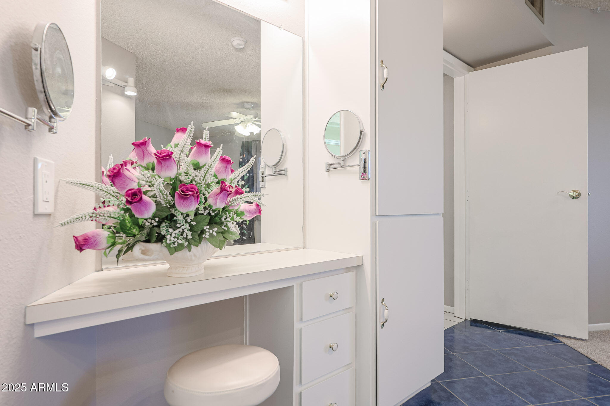 14022 North Palm Ridge Drive Sun City, AZ 85351 - Photo 19 of 21 a bathroom with a sink mirror and vanity