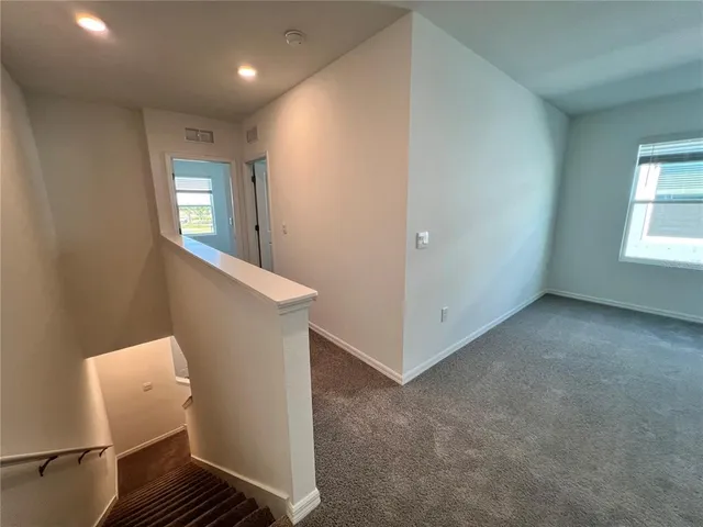 a view of an empty room with windows