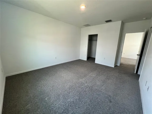 a spacious bathroom with a granite countertop sink a mirror and a vanity