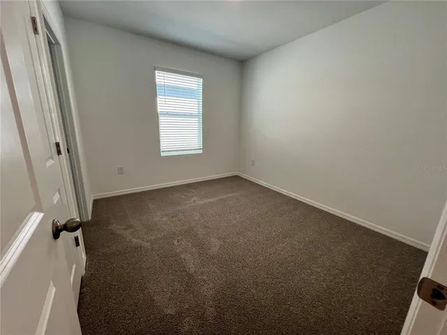 a view of an empty room and a window