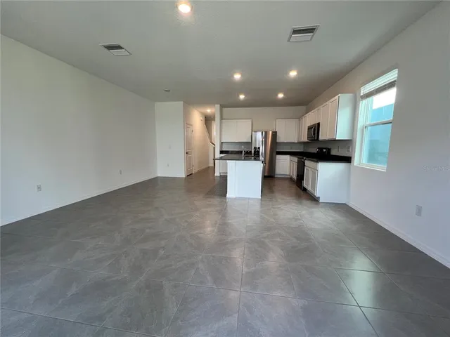 a view of a kitchen and dining room
