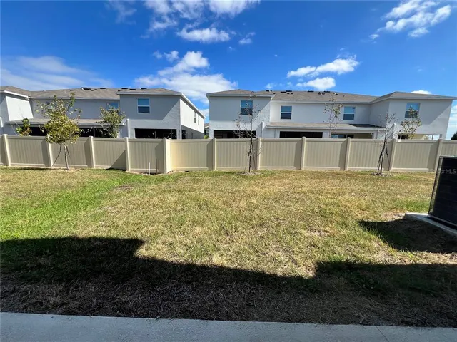 a large white kitchen with large trees