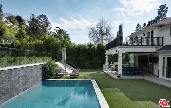a view of swimming pool with a patio