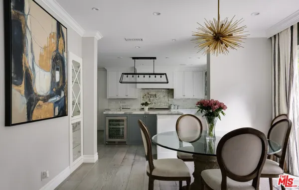 a dining room with kitchen island a table and chairs