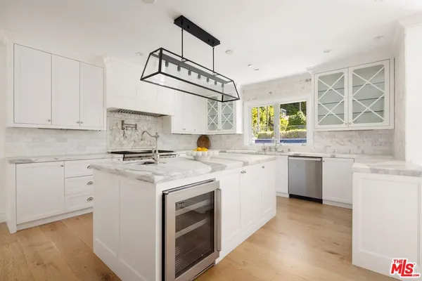 a kitchen with stainless steel appliances granite countertop a sink and a stove