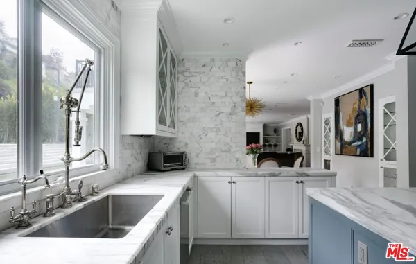 a kitchen with a sink stove and cabinets