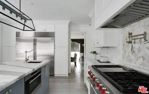 a kitchen with granite countertop a sink and stainless steel appliances