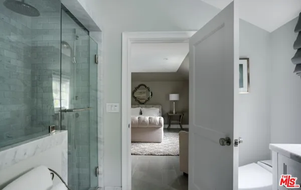 a bathroom with a glass door shower