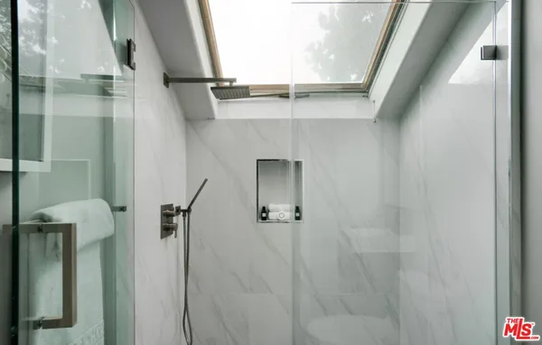 a bathroom with a shower and a sink