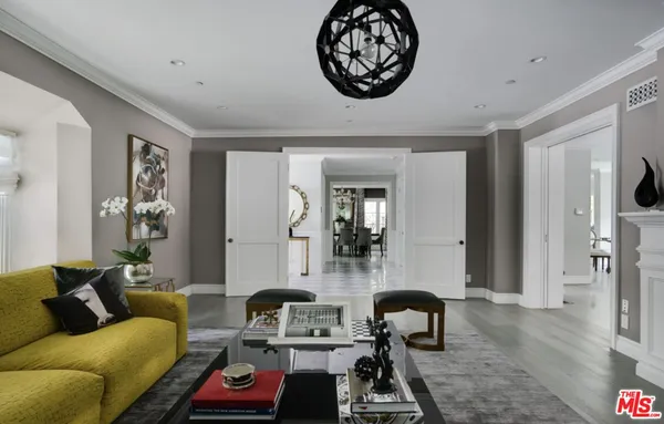 a living room with furniture a couch and wooden floor