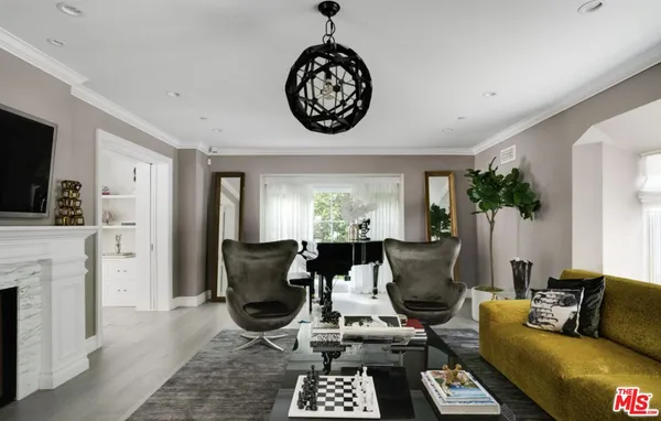 a living room with furniture a fireplace and a flat screen tv