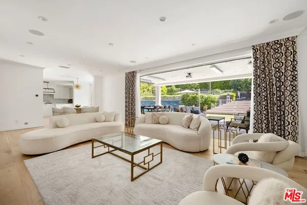 a living room with dining table and a fireplace