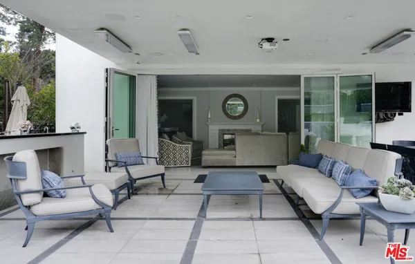 a living room with furniture and a clock