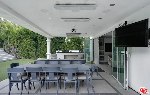 a view of an outside dining space with furniture window and wooden floor