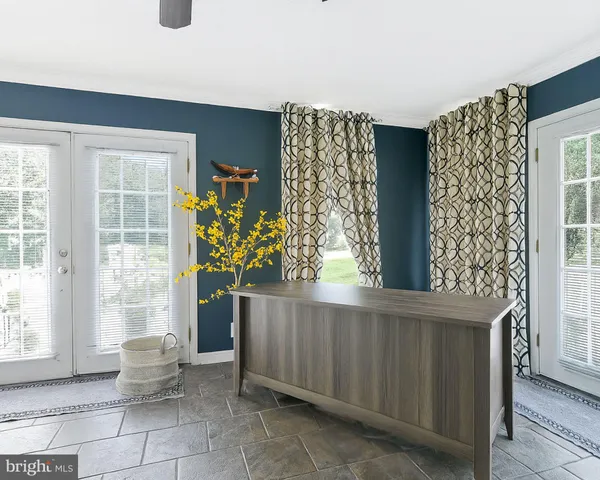 a room with a window and potted plants