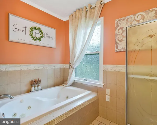 a bathroom with a tub a sink and a window