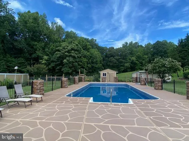a view of a swimming pool with a patio
