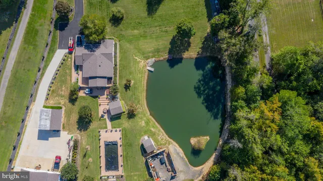 an aerial view of a house with outdoor space and a lake view