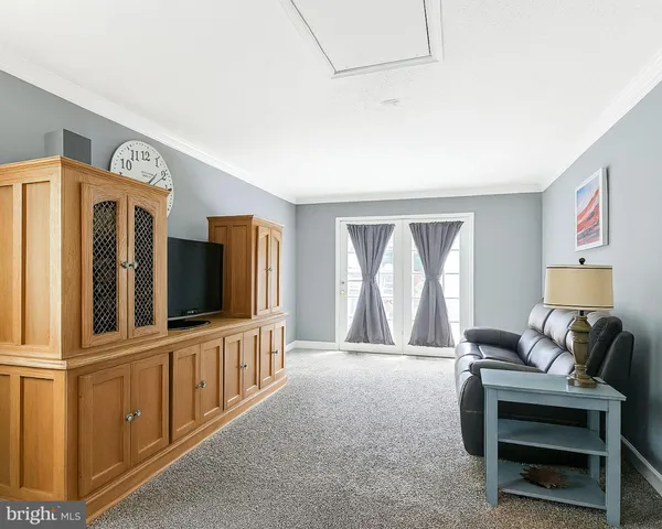 a living room with furniture and flat screen tv