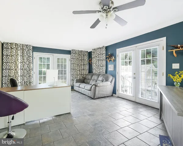 a living room with furniture and a floor to ceiling window