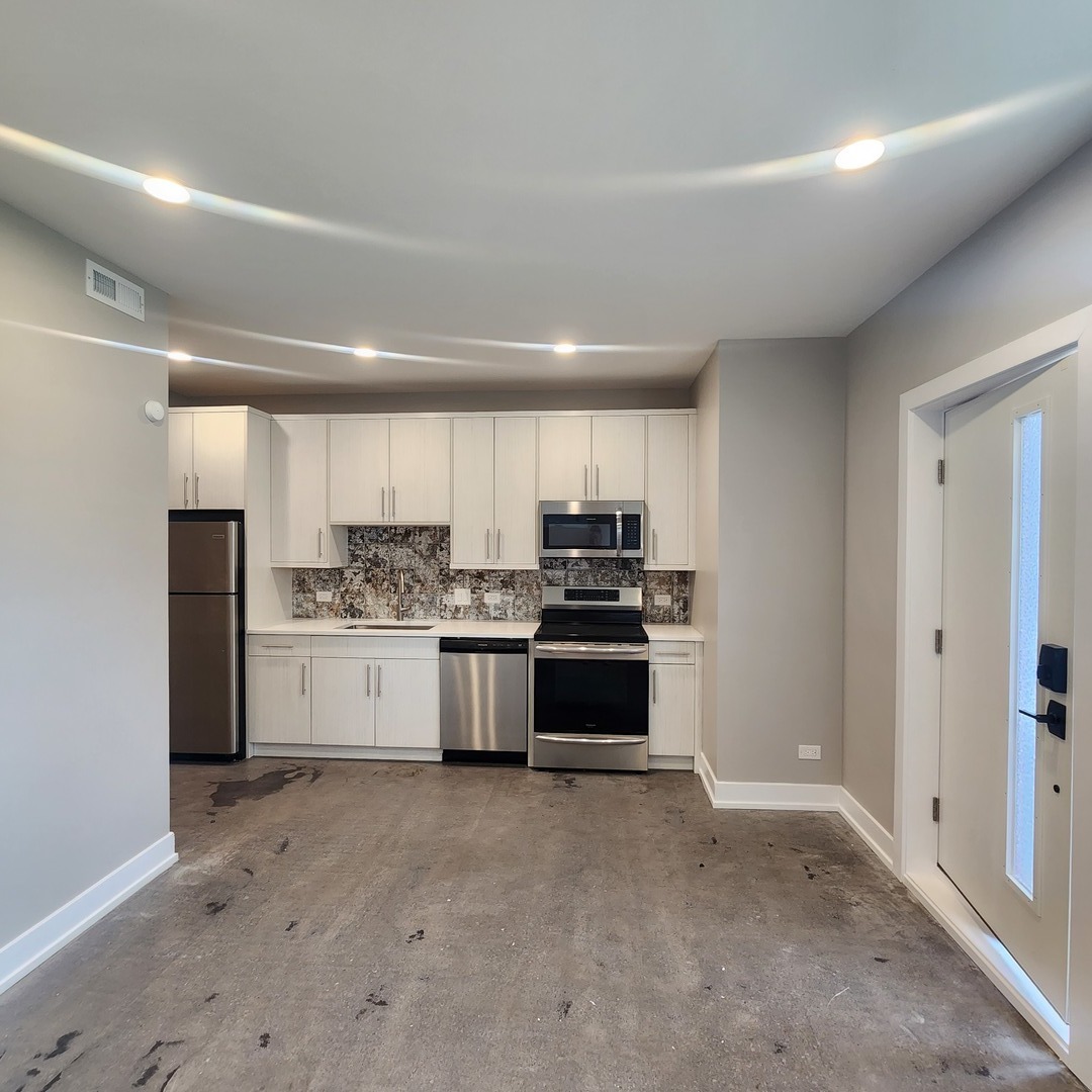 1221 East Marquette Road, Unit G Chicago, IL 60637 - Photo 2 of 11 a kitchen with stainless steel appliances a refrigerator and white cabinets