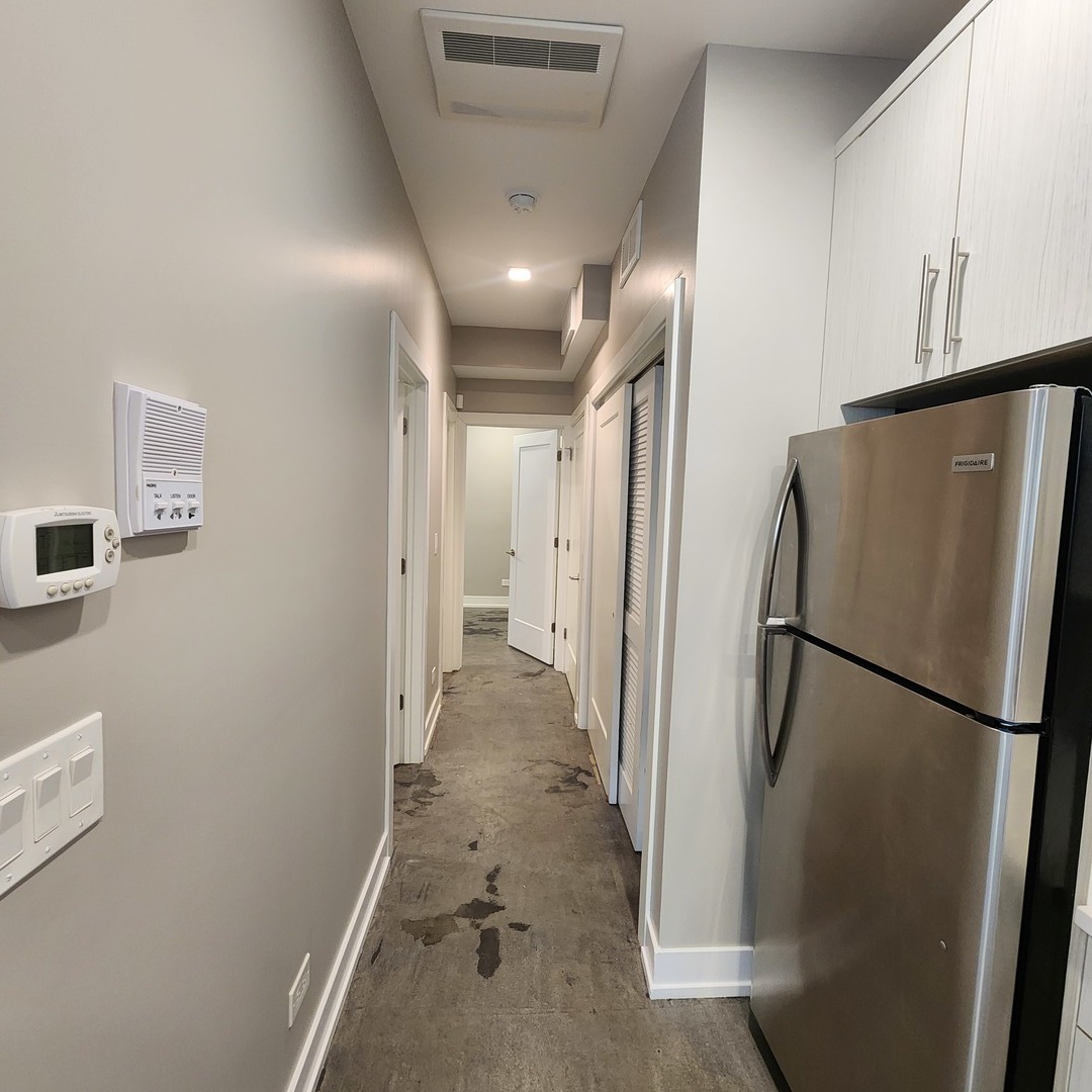 1221 East Marquette Road, Unit G Chicago, IL 60637 - Photo 4 of 11 a view of a refrigerator in kitchen and an empty room