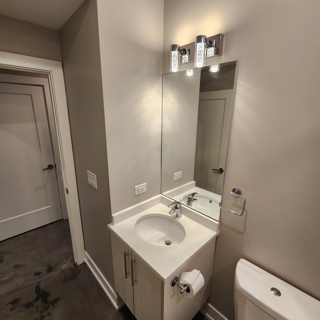 1221 East Marquette Road, Unit G Chicago, IL 60637 - Photo 8 of 11 a bathroom with a sink toilet and mirror