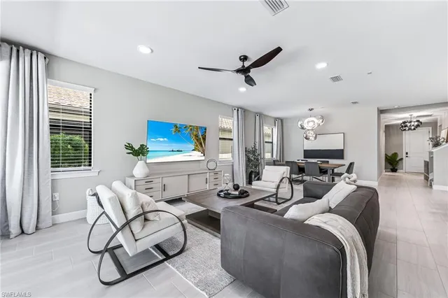 a living room with furniture and a potted plant