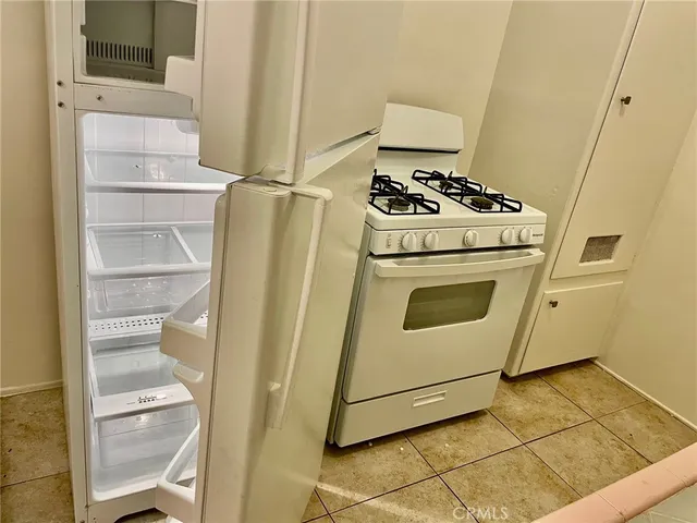 a kitchen with a sink stove and refrigerator
