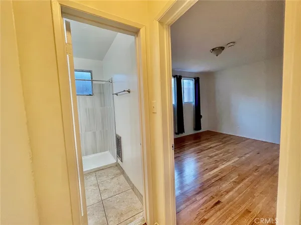 a view of a room with wooden floor and sliding door