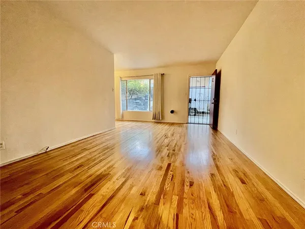 a view of a room with wooden floor and cabinet