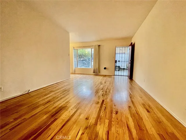 a view of a room with wooden floor and cabinet