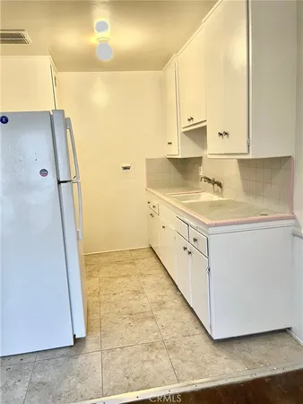 a kitchen with stainless steel appliances a refrigerator and a stove