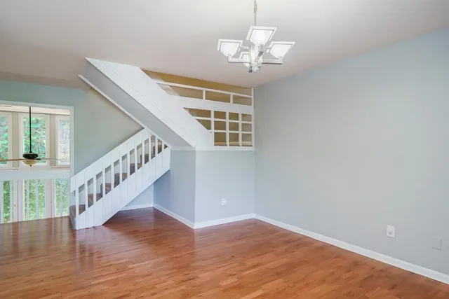 a view of wooden floor and chandelier in a room
