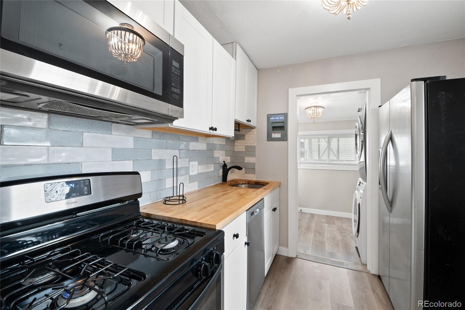 2045 Eaton Street Edgewater, CO 80214 - Photo 11 of 28 a kitchen with a stove and a refrigerator