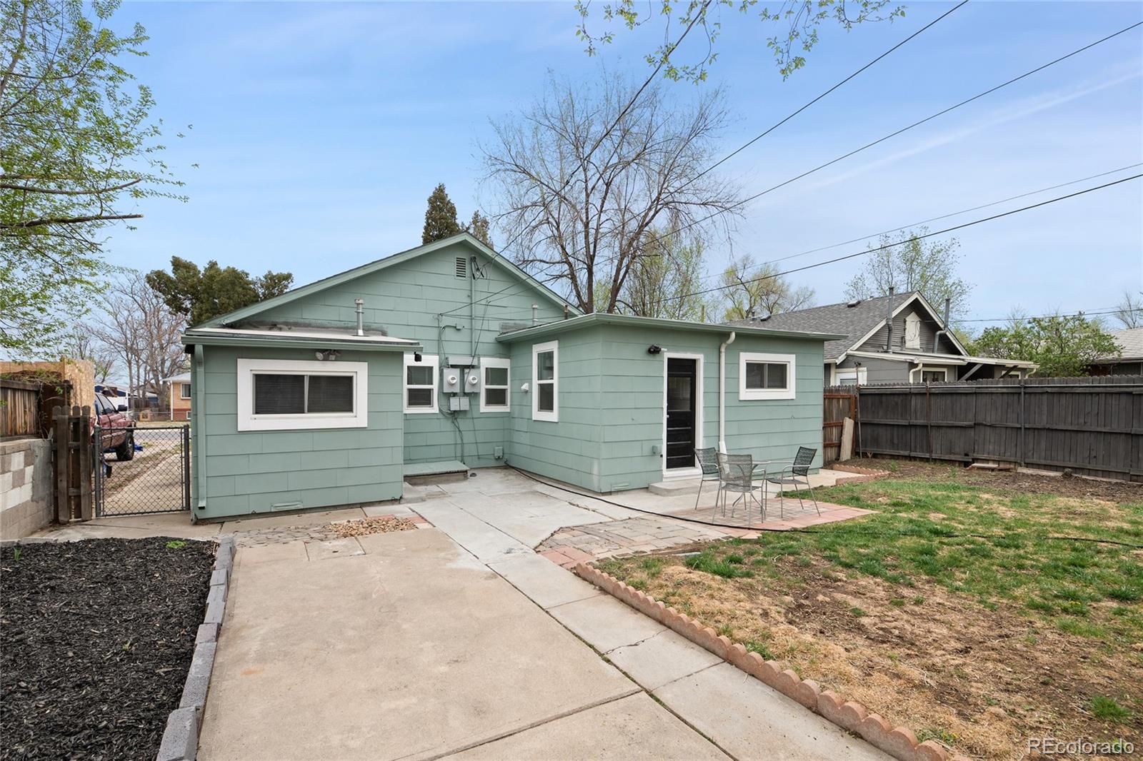 2045 Eaton Street Edgewater, CO 80214 - Photo 16 of 28 a front view of a house with garden