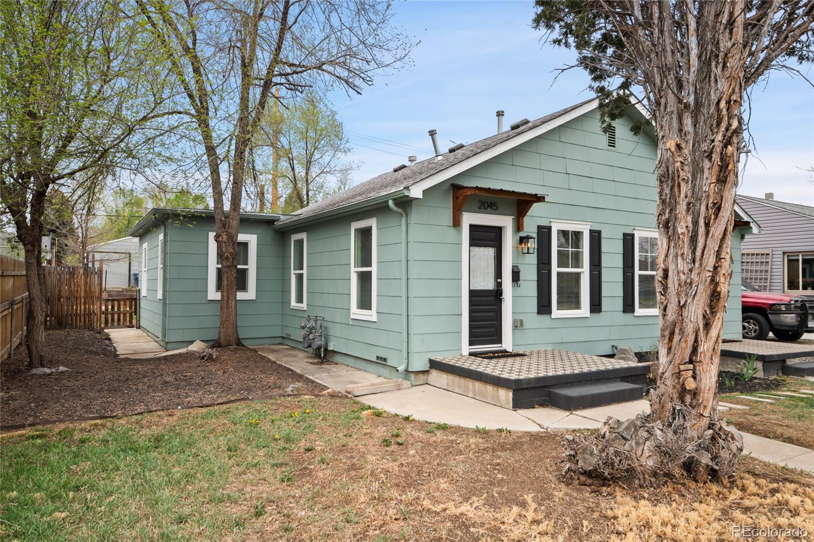 2045 Eaton Street Edgewater, CO 80214 - Photo 17 of 28 a front view of a house with garden