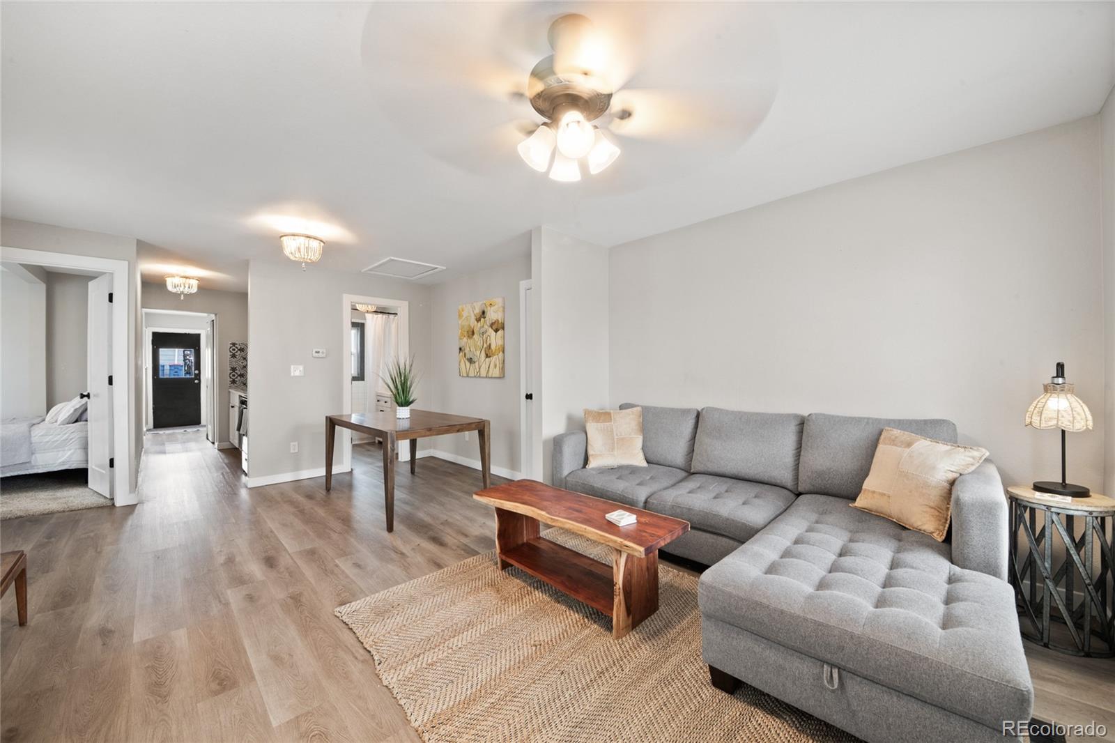2045 Eaton Street Edgewater, CO 80214 - Photo 2 of 28 a living room with furniture and a chandelier