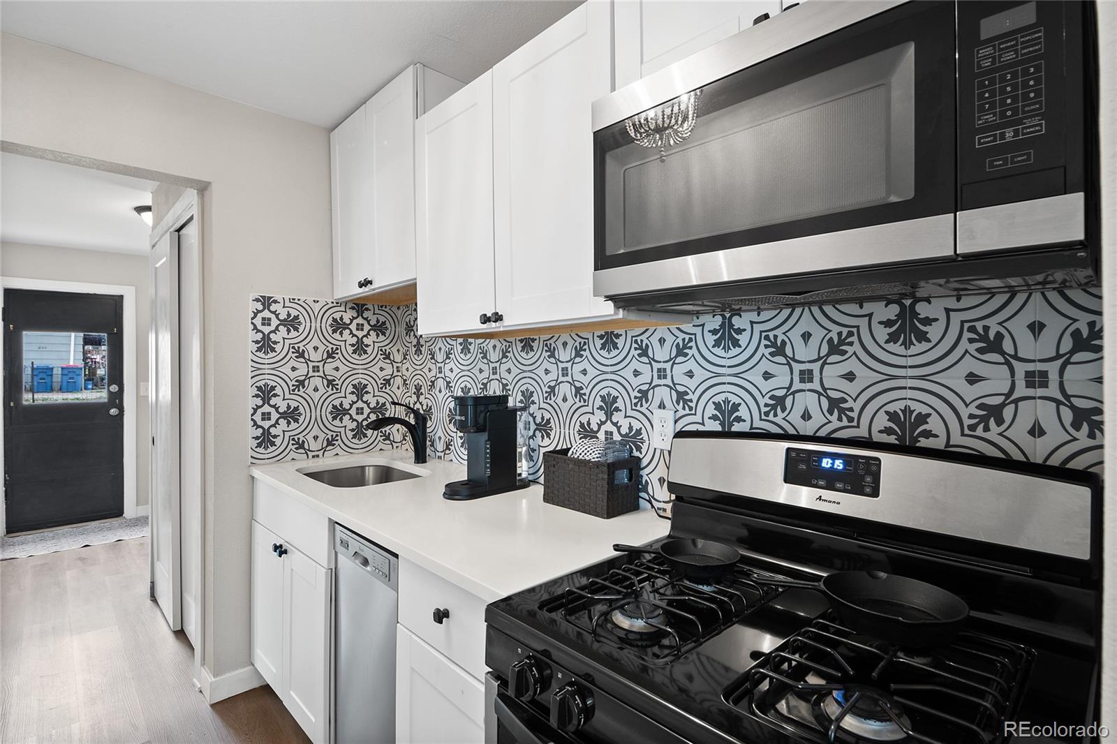 2045 Eaton Street Edgewater, CO 80214 - Photo 21 of 28 a kitchen with stainless steel appliances a stove and cabinets